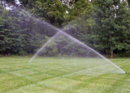 Lawn sprinkler system watering a green residential lawn in Charlotte, NC