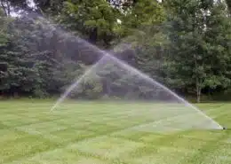 Lawn sprinkler system watering a green residential lawn in Charlotte, NC