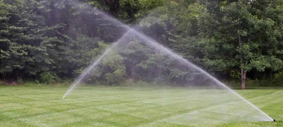 Lawn sprinkler system watering a green residential lawn in Charlotte, NC