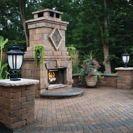 stylish outdoor fire place by charlotte lighting and hardscapes