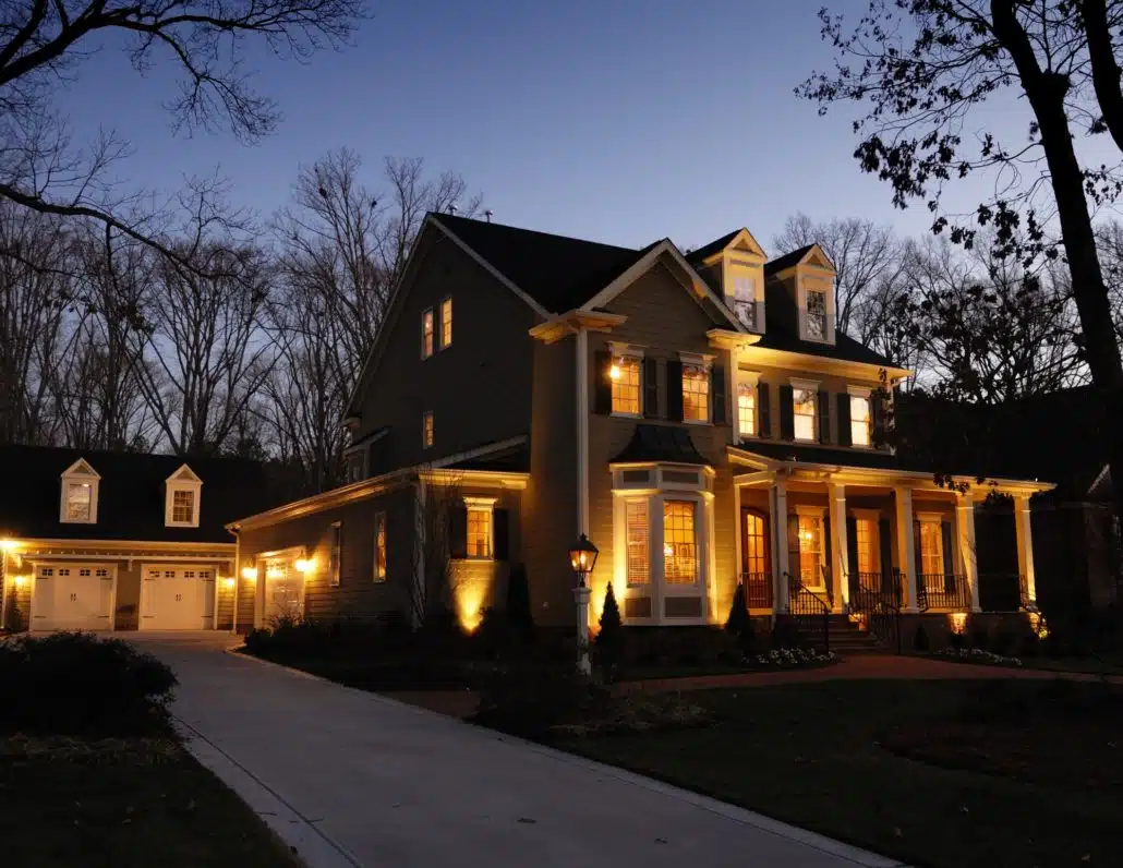Charlotte Lighting & Hardscapes offers affordable solutions in the Charlotte Metro area. Landscape lighting, Hardscapes and Artificial Turf solutions, a house with lights on the front, outdoor lighting trends