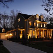 Charlotte Lighting & Hardscapes offers affordable solutions in the Charlotte Metro area. Landscape lighting, Hardscapes and Artificial Turf solutions, a house with lights on the front, outdoor lighting trends