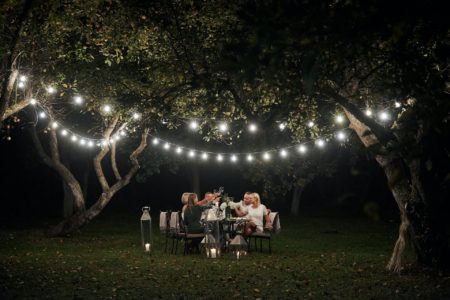 Bistro string lights over a paver patio outdoor living space in Charlotte, NC