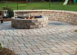Outdoor fireplace on a paver patio for cool-weather use in Charlotte, NC
