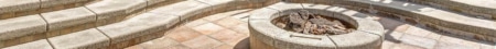 Charlotte Lighting & Hardscapes | Fire Pit vs. Outdoor Fireplace: Which Is Right for Your Charlotte Backyard? Custom stone outdoor fireplace on a paver patio in Charlotte, NC