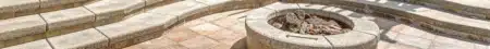 Custom stone outdoor fireplace on a paver patio in Charlotte, NC
